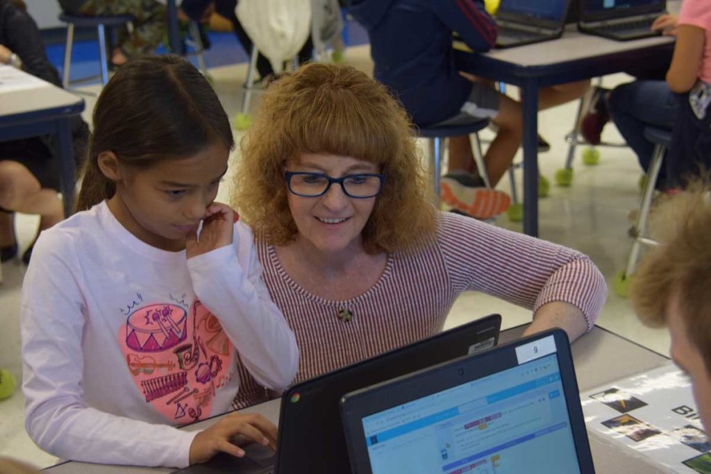 Kathleen Schofield Working with Student in Computer Science Lab